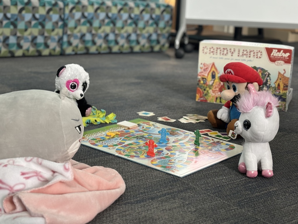 Stuffed friends enjoying a game of Candy Land.