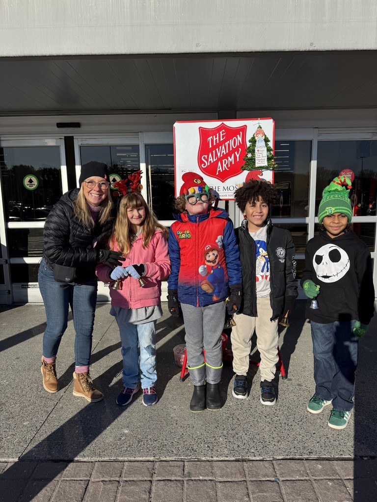 4 students and their teacher volunteering in front of Salvation Army