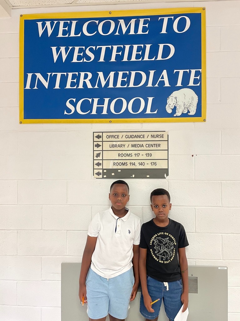 Students in front of school sign