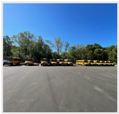 Paving a bus garage lot significantly reduces physical wear, corrosion, and component failure on fleet undercarriages compared to unpaved dirt or gravel surfaces.