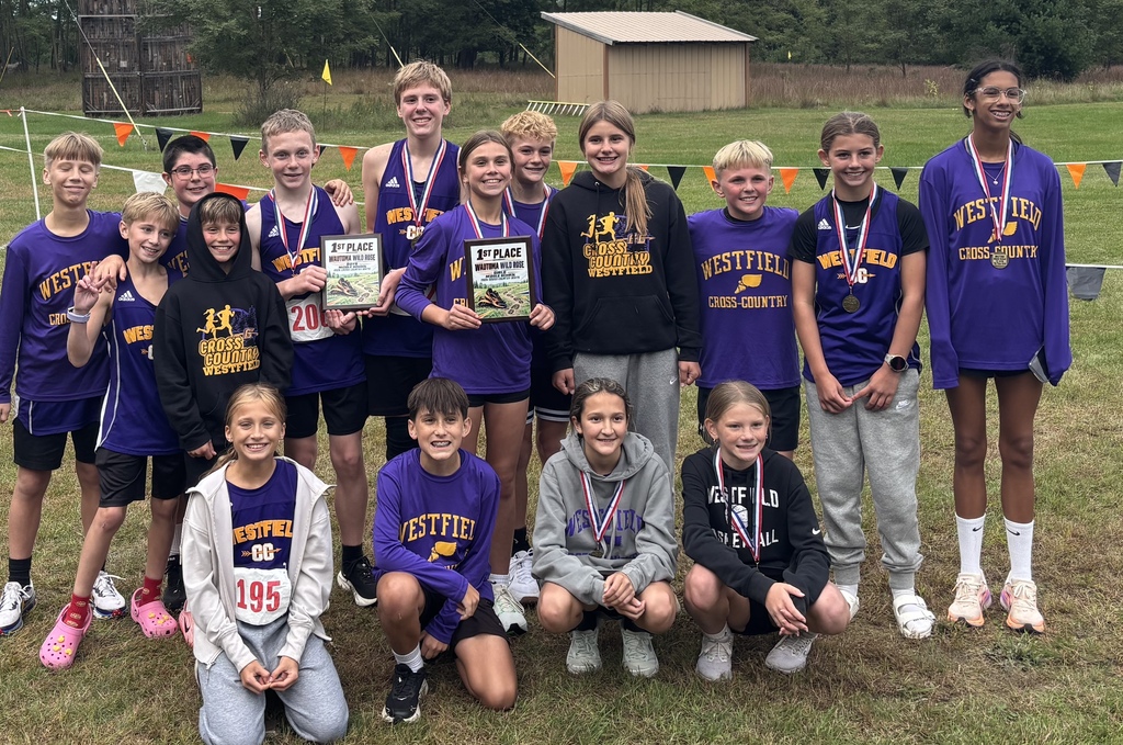 Middle school cross country team with medals