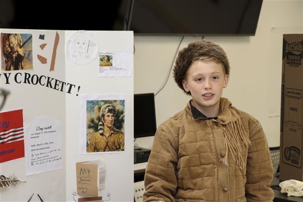a small boy dressed as Davy Crockett