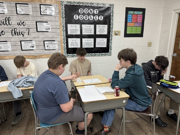 Algebra students are having fun reviewing slope and linear equations with a board game!