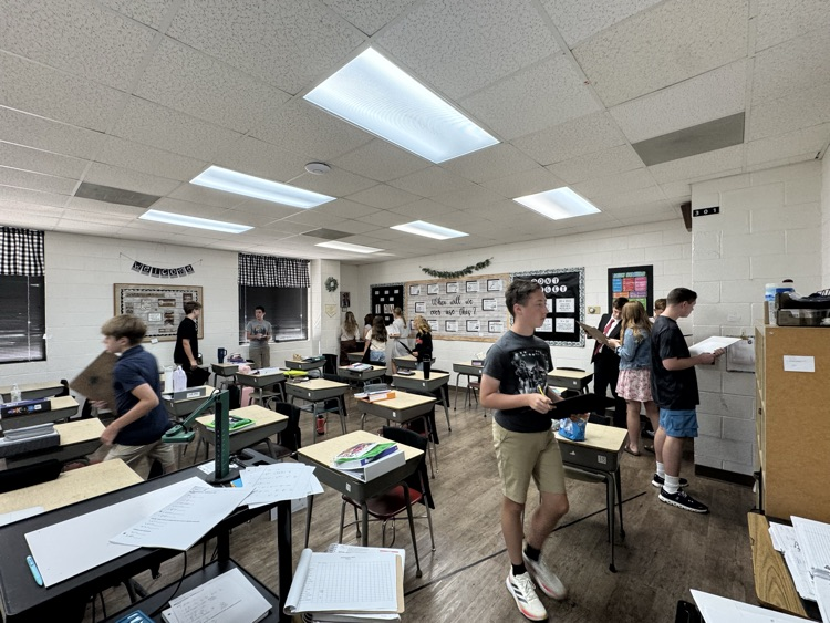 Algebra students are reviewing exponent rules with a scavenger hunt.