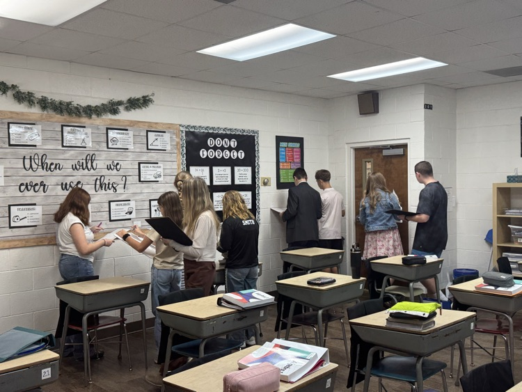 Algebra students are reviewing exponent rules with a scavenger hunt.