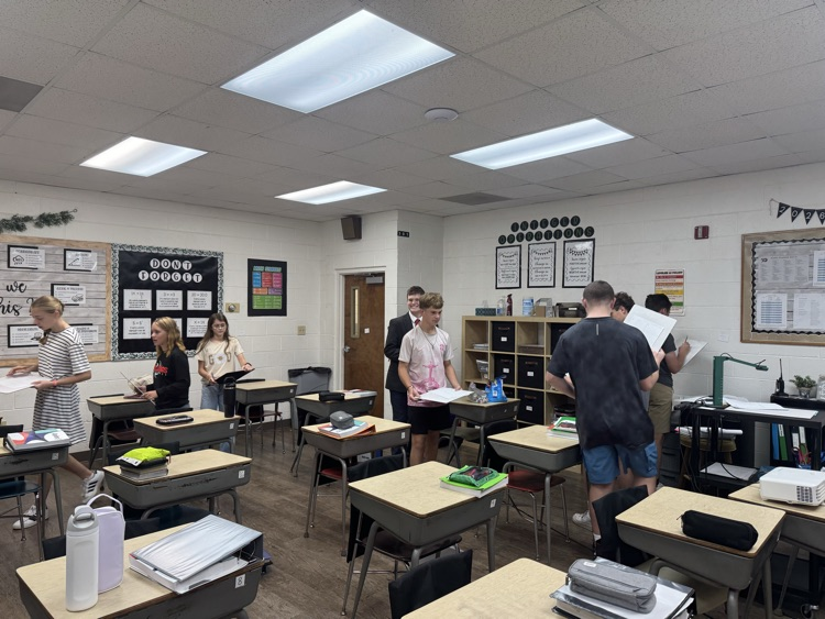 Algebra students are reviewing exponent rules with a scavenger hunt.