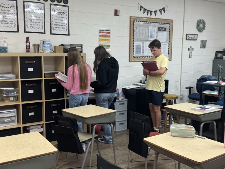Algebra students are reviewing exponent rules with a scavenger hunt.