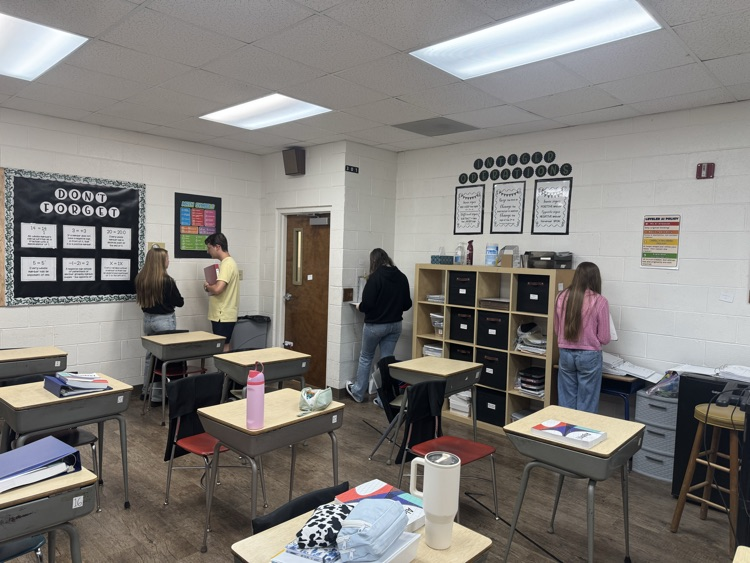 Algebra students are reviewing exponent rules with a scavenger hunt.