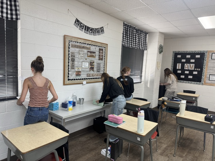 Algebra students are reviewing exponent rules with a scavenger hunt.