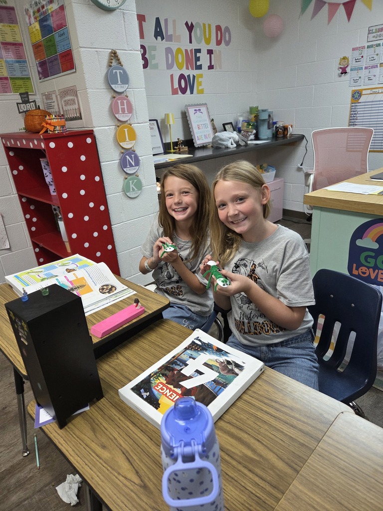 4th graders showing off their arthropods in science.