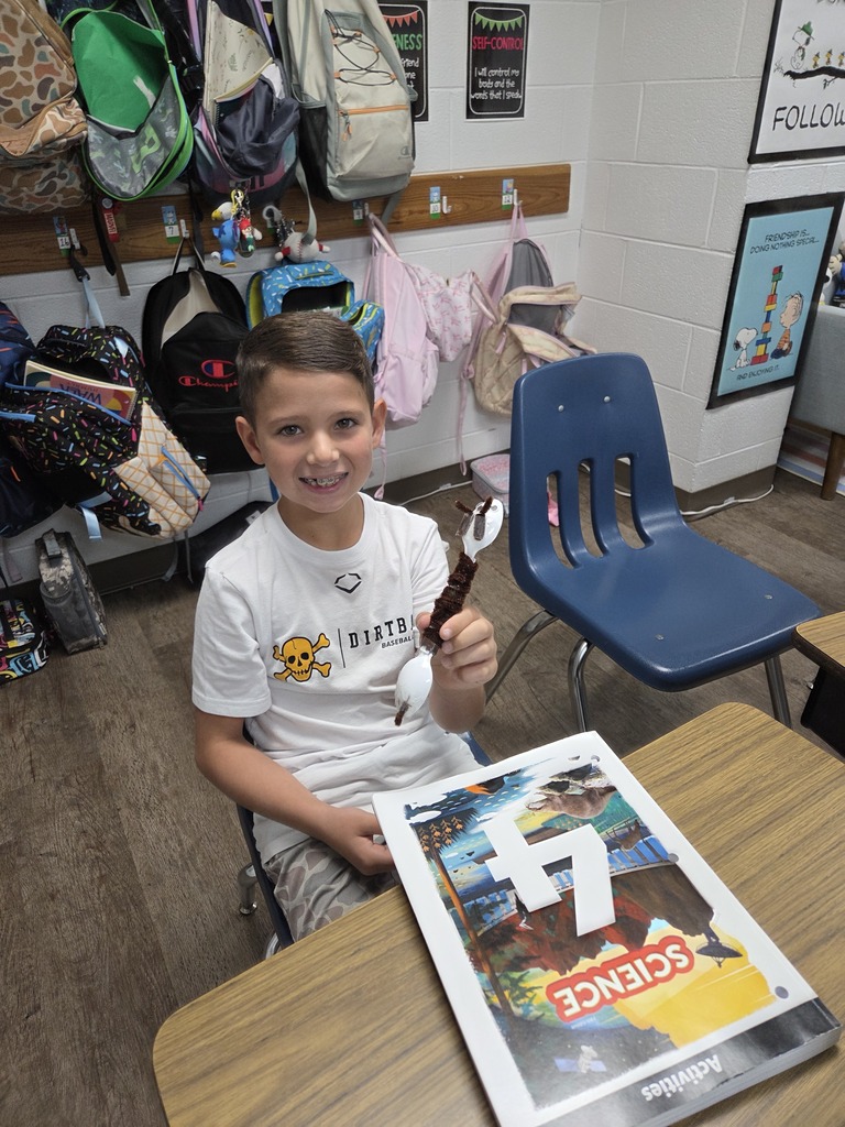 4th graders showing off their arthropods in science.