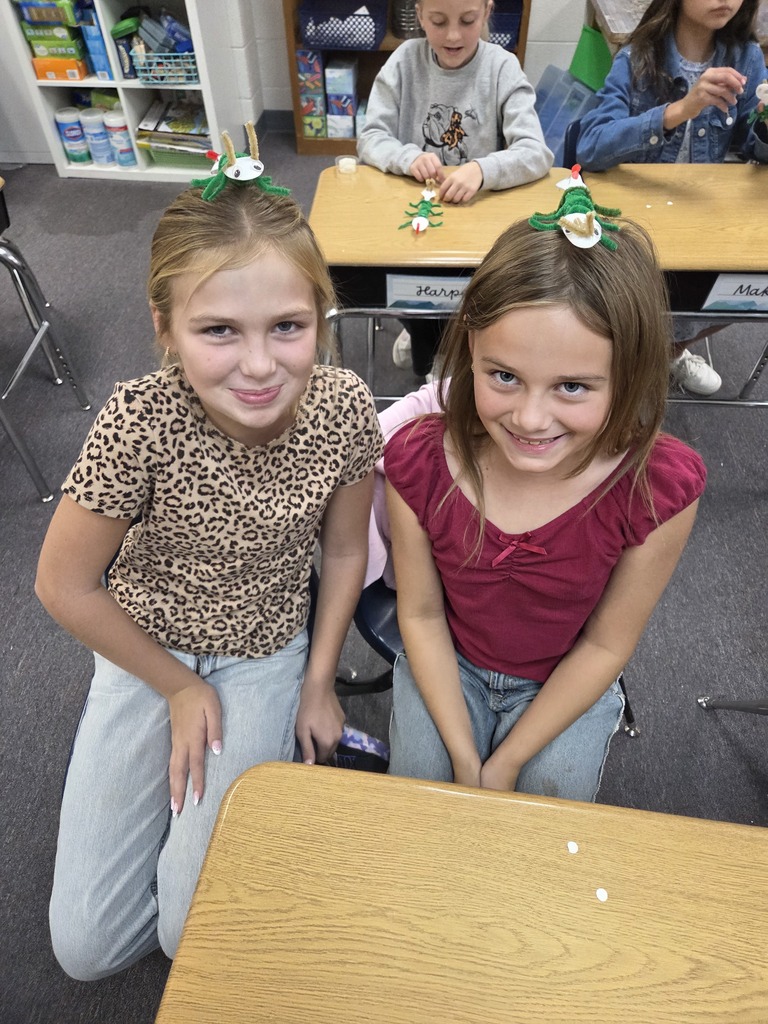 4th graders showing off their arthropods in science.