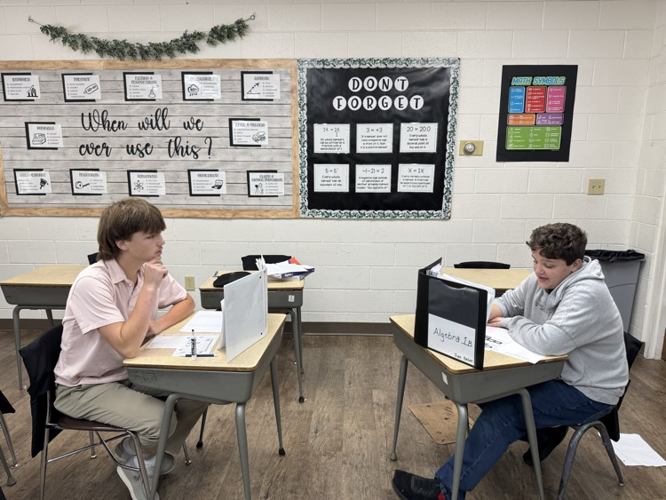 Algebra 1 students are practicing factoring trinomials into binomials with a game of battleship.