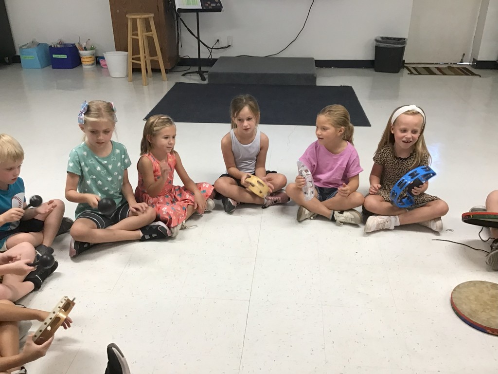 First grade playing rhythm instruments.