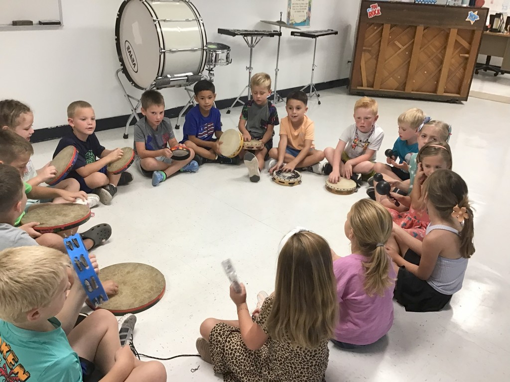 First Grade playing rhythm instruments.