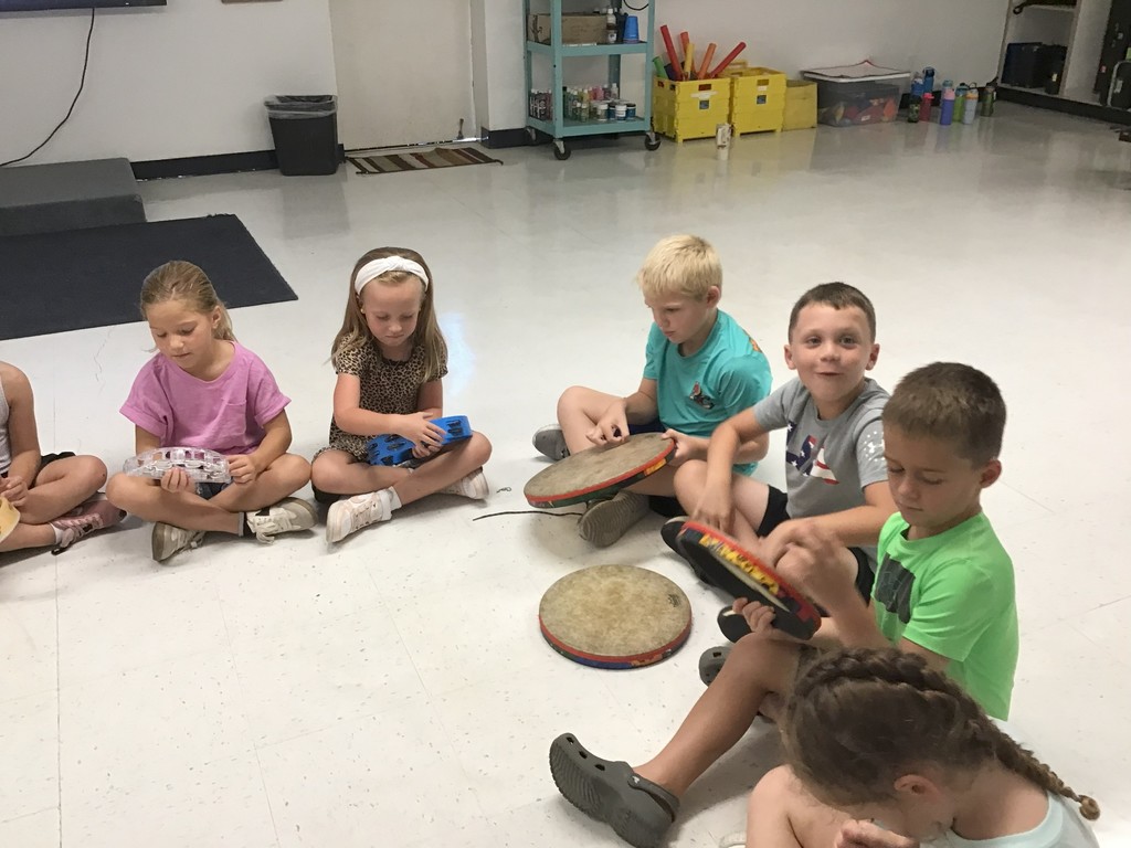 First Grade playing rhythm instruments.