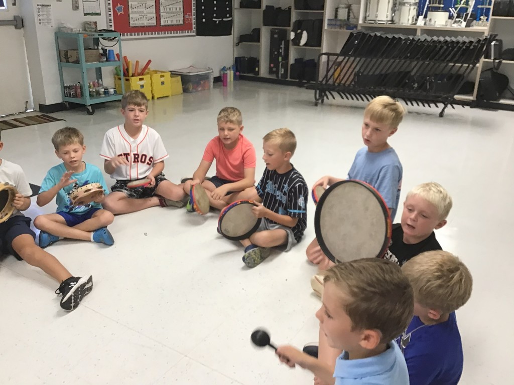 Third Grade playing rhythm instruments to a dum pah beat.