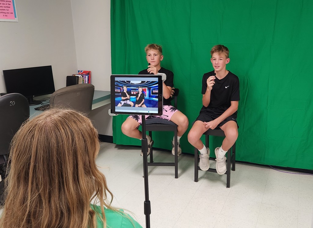 Students recording with green screen