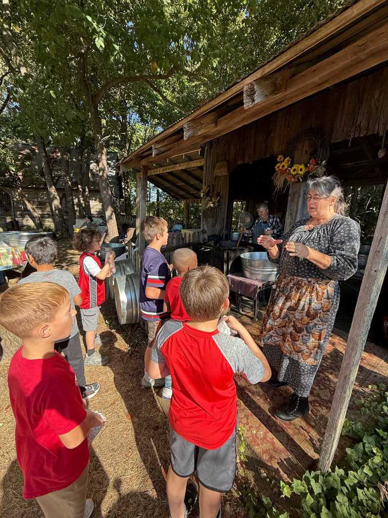 Today, WES 4th graders stepped back in time with a visit to Parker Pioneer Homestead near Harrisburg. The Homestead is a recreated 19th-century town where history comes alive through historic buildings, artifacts, and hands-on experiences.  Students had a wonderful time exploring life as it was in the past — and one special highlight was seeing our very own Mrs. Deana Bonham join in by playing the fiddle alongside the local band.