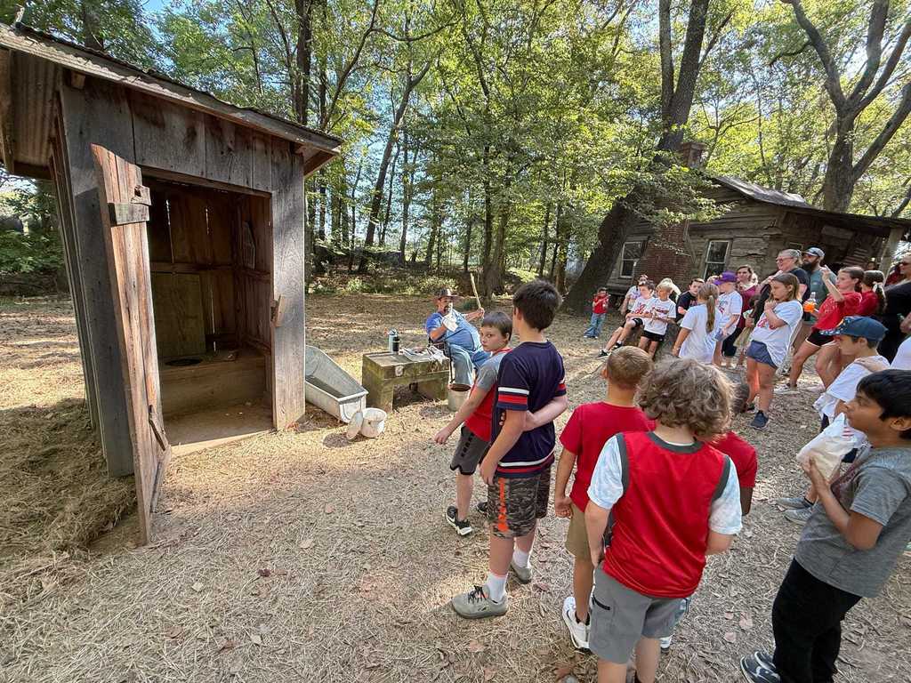Today, WES 4th graders stepped back in time with a visit to Parker Pioneer Homestead near Harrisburg. The Homestead is a recreated 19th-century town where history comes alive through historic buildings, artifacts, and hands-on experiences.  Students had a wonderful time exploring life as it was in the past — and one special highlight was seeing our very own Mrs. Deana Bonham join in by playing the fiddle alongside the local band.