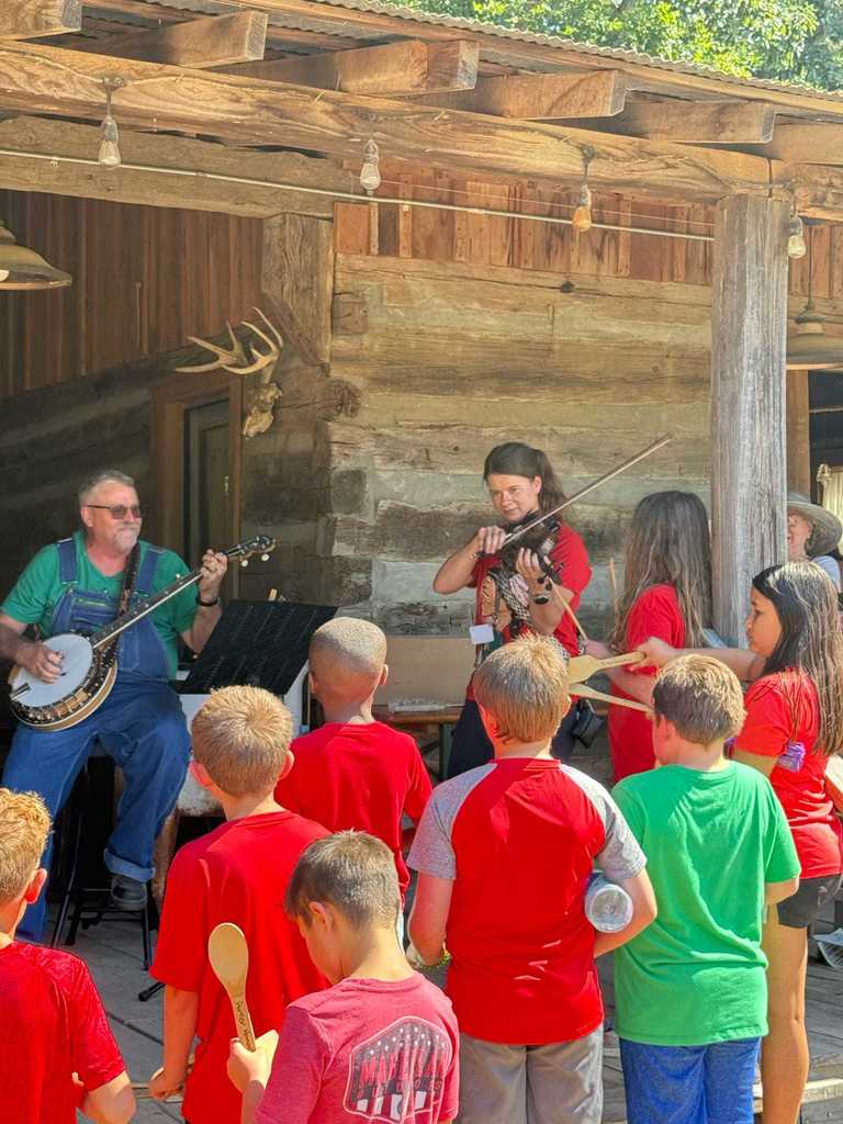 Today, WES 4th graders stepped back in time with a visit to Parker Pioneer Homestead near Harrisburg. The Homestead is a recreated 19th-century town where history comes alive through historic buildings, artifacts, and hands-on experiences.  Students had a wonderful time exploring life as it was in the past — and one special highlight was seeing our very own Ms. Deana Bonham join in by playing the fiddle alongside the local band.