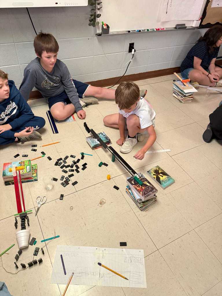 Ms. Cline’s 4th grade science students have been learning all about energy and energy transfer, and today they put their knowledge to the test!   Students worked in teams to design and build chain reaction models using materials from around the classroom. They explored how motion and energy move from one object to another — discovering real-world examples of cause and effect.  Great job, Warriors!  ❤️🤍