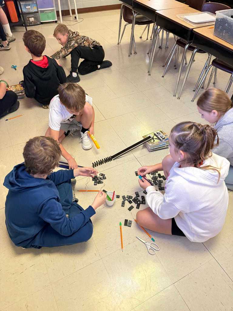 Ms. Cline’s 4th grade science students have been learning all about energy and energy transfer, and today they put their knowledge to the test!   Students worked in teams to design and build chain reaction models using materials from around the classroom. They explored how motion and energy move from one object to another — discovering real-world examples of cause and effect.  Great job, Warriors!  ❤️🤍