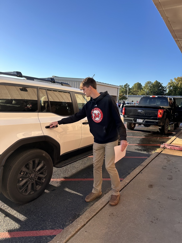 WHS Boys Basketball team brought the spirit to Westside Elementary this morning! 🏀❤️🤍  Players helped open car doors and greeted students with big smiles to start the day, then joined the morning meeting to pump up our Lil Warriors and their families for tonight’s Red & White Game!  Join us for an evening full of fun — BBQ dinner, alumni game, Lil Dribblers performance, and Lil Cheer! Festivities kick off at 5:30 p.m. at WHS.