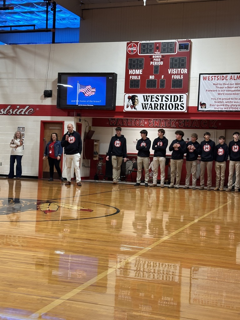 WHS Boys Basketball team brought the spirit to Westside Elementary this morning! 🏀❤️🤍  Players helped open car doors and greeted students with big smiles to start the day, then joined the morning meeting to pump up our Lil Warriors and their families for tonight’s Red & White Game!  Join us for an evening full of fun — BBQ dinner, alumni game, Lil Dribblers performance, and Lil Cheer! Festivities kick off at 5:30 p.m. at WHS.