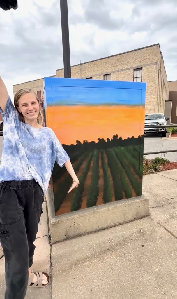 ❤️🤍A Little Piece of Westside in Downtown Jonesboro ❤️🤍 One of our own is sharing the beauty of Westside with the city of Jonesboro in a truly special way.  Hi friends, I’m Cady Honeycutt 👋🏼  Every weekday morning, I drive a school bus for Westside. Because I have an extended route, I typically begin my drive in the dark. This also means I get to see the sunrise every morning. Part of my route takes us down dirt roads that are sandwiched between fields and fields. And even more fields.  Honestly, the view never gets old. I love seeing the world wake up slowly - the colorful morning rays peeking over the tree tops, the crops gently swaying in the wind, the birds gracefully flittering by. It’s something I look forward to every single morning.  Occasionally, The Foundation of Arts in Jonesboro opens submissions to beautify traffic control boxes throughout the area. I have always been intrigued by the different designs chosen and wanted to be a part of it. This year, when the FOA announced they were accepting submissions, I knew exactly what I wanted to send in.  I painted this awe-inspiring scene in hopes of being selected. After a month or so, I was contacted by the FOA notifying me that I was selected to paint the traffic control box on Matthews and Church Street in downtown Jonesboro. My jaw dropped with equal amounts of shock and excitement.  I am incredibly thankful for the opportunity to share a glimpse of the hard work and dedication our Westside community provides to NEA.