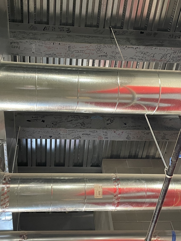 Soon, these beams will be covered as construction continues on the new addition to Westside High School. But underneath the walls and ceilings will remain something pretty special — the names and messages of the students, staff, alumni, families, and community members who helped make their mark on this new chapter of Westside.