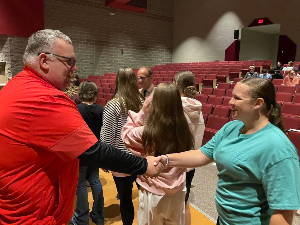 Chandler Engle shaking hands with Mr. Bajdek