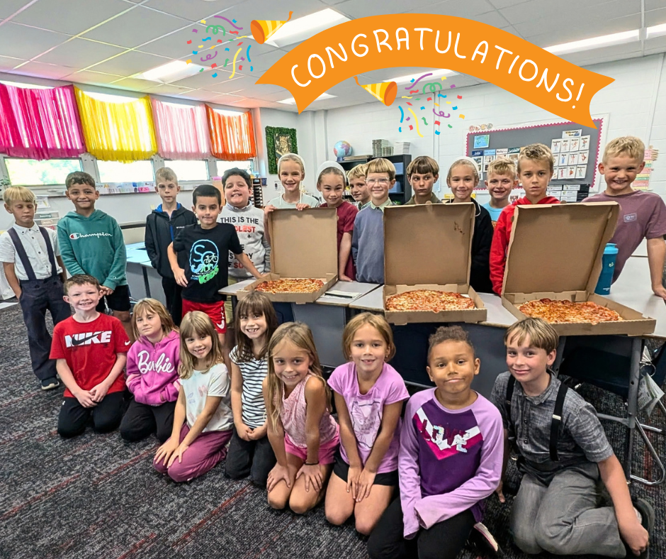 students in 2B posing with their pizza for the party