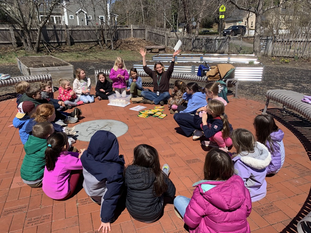 Class sitting in a circle outside