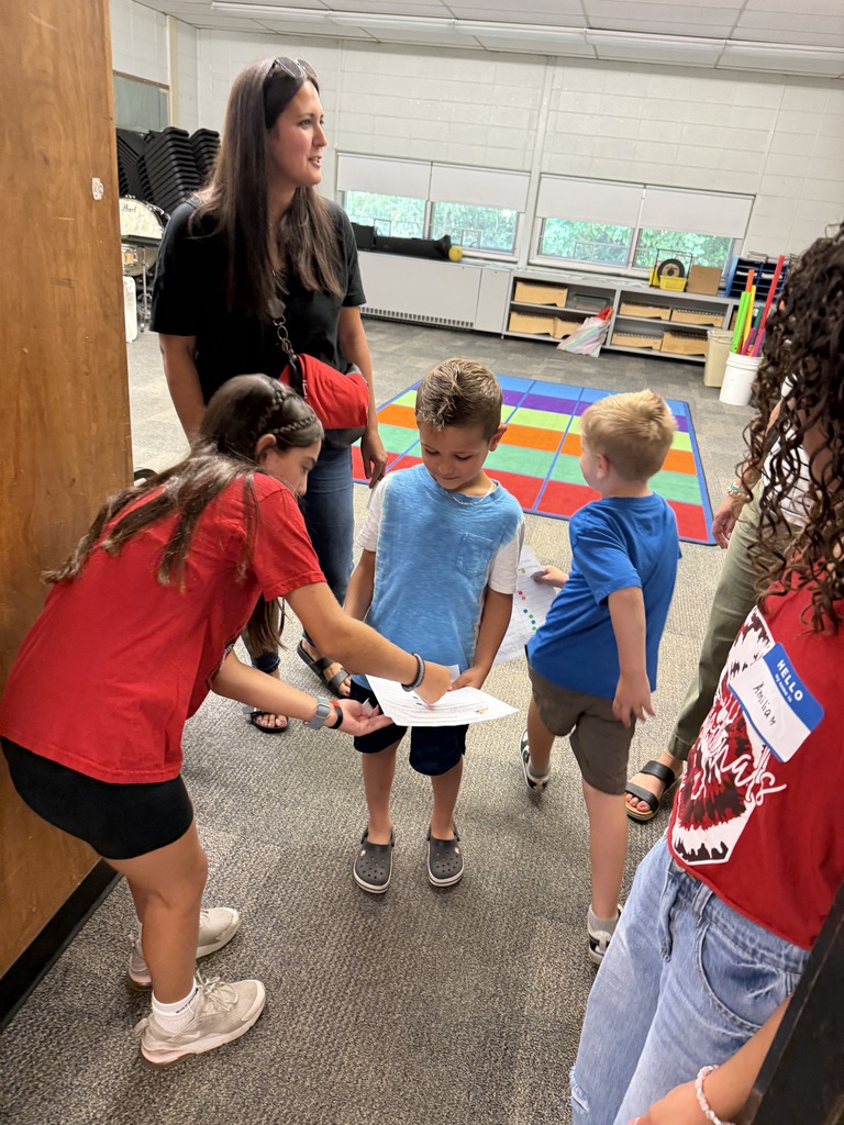 students in a classroom helping others