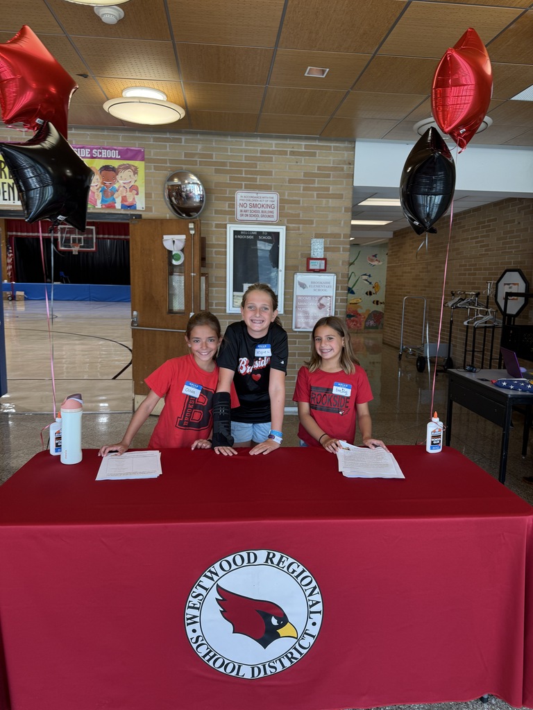 3 students in front of a table