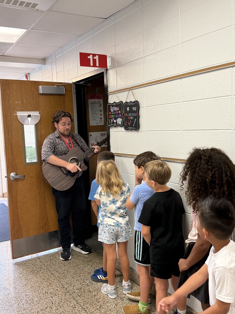 teacher with guitar and students