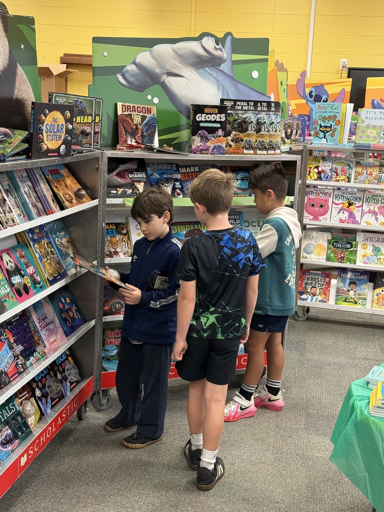 students looking at books