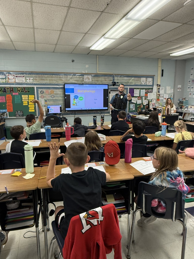 cop and students in classroom