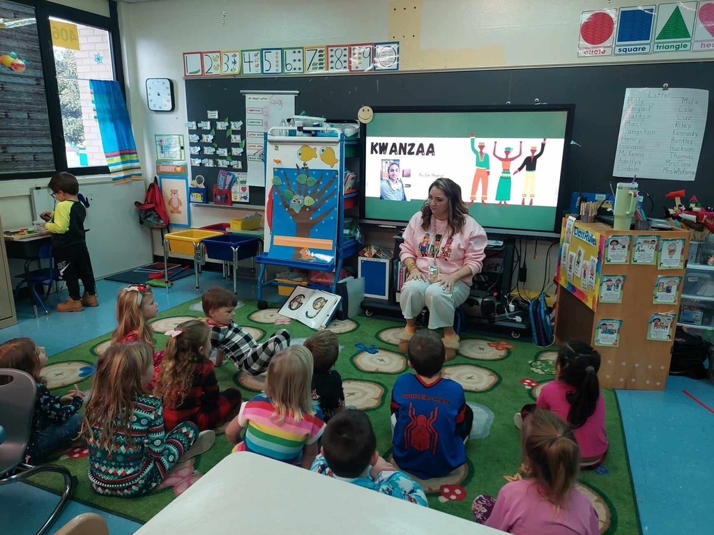 Mrs. Caneen teaches a group of students about Kwanzaa