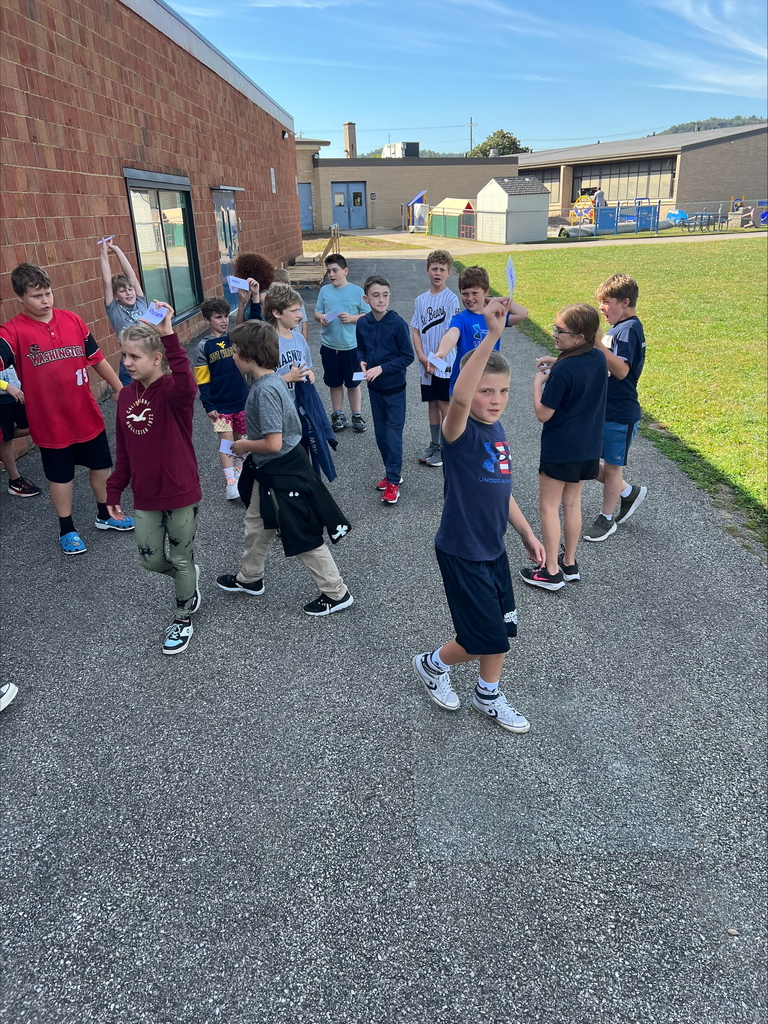 Students lining up along with Miss Long as a the decimal point. 