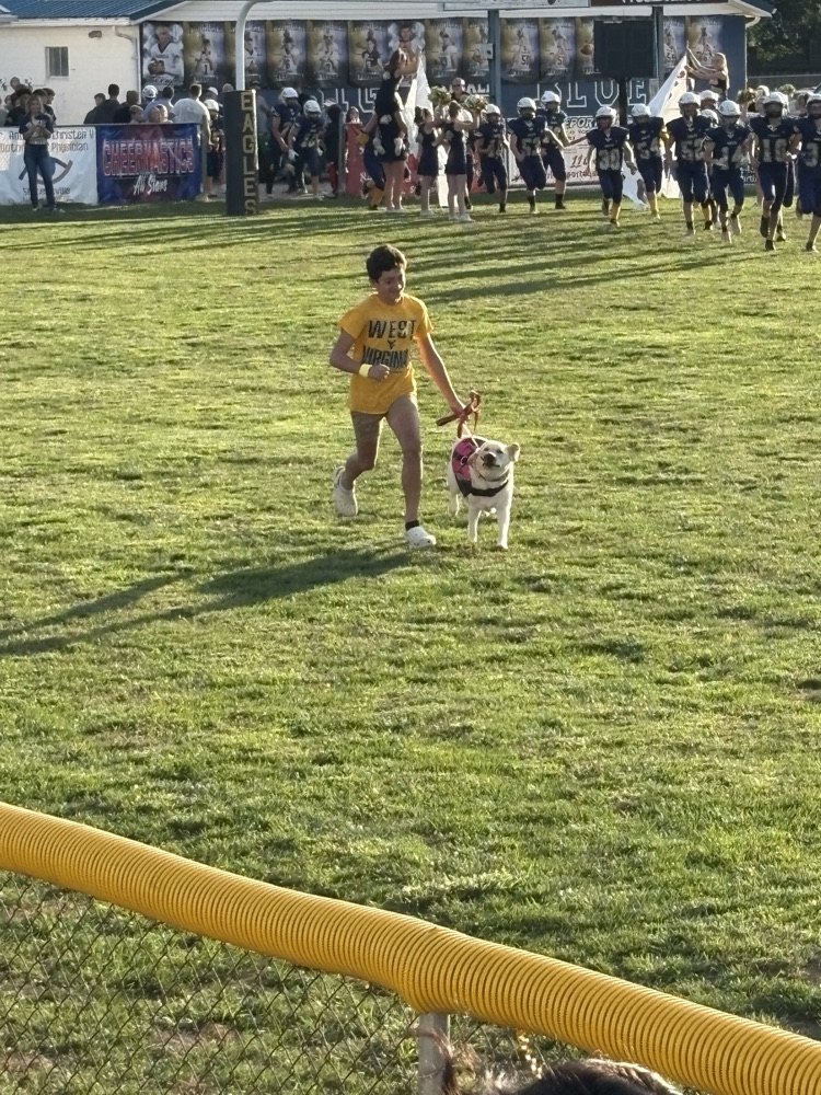 student in gold leads out the eagles with Molly.  