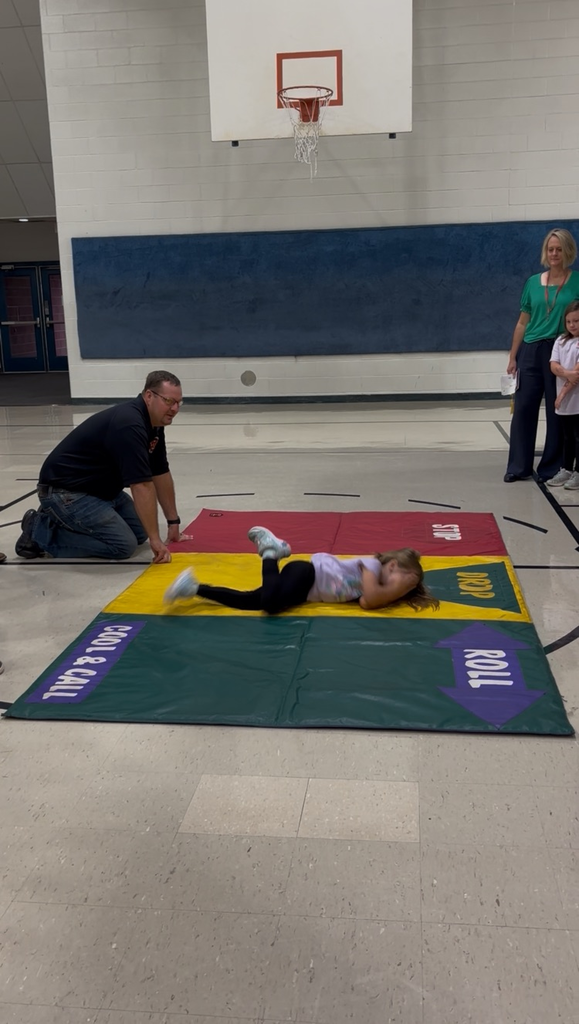 kindergarten Kids learn how to stop,  drop, and roll. 