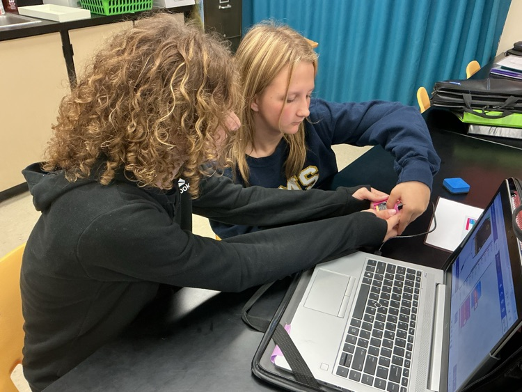 two student coding microbot on computer 