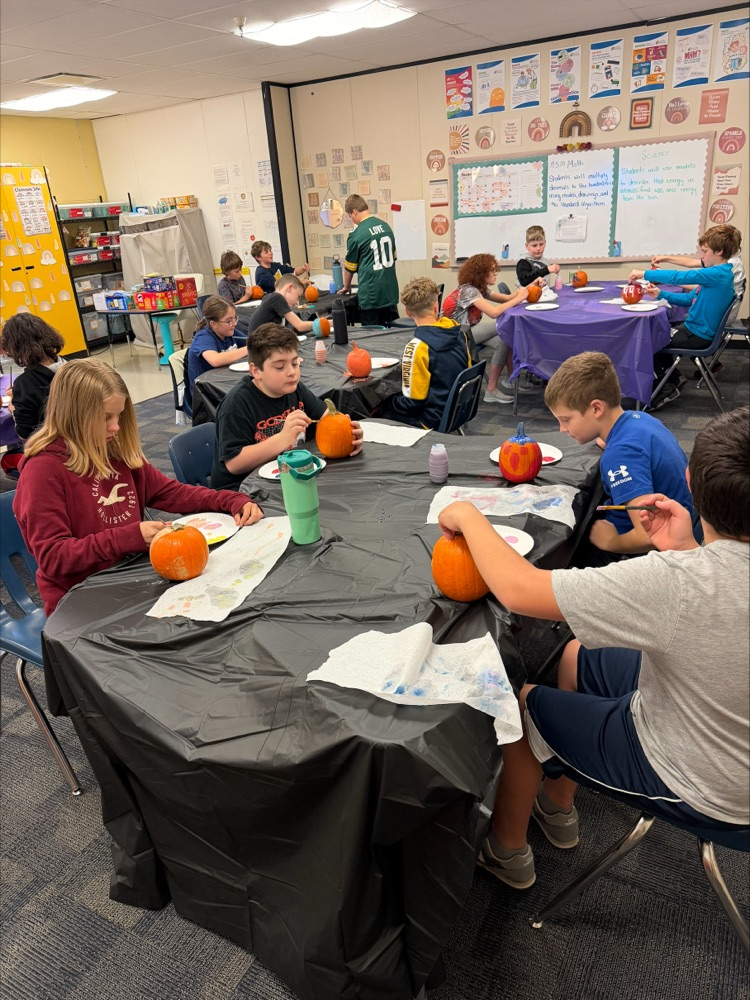 Students painting pumpkins  