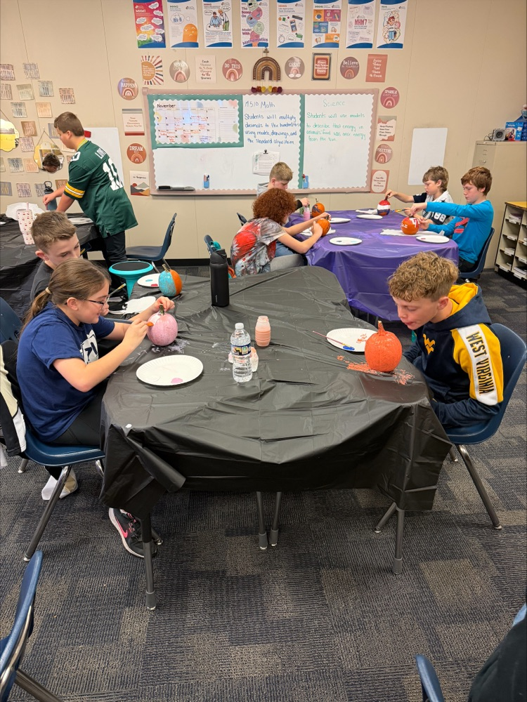 Students painting pumpkins. 