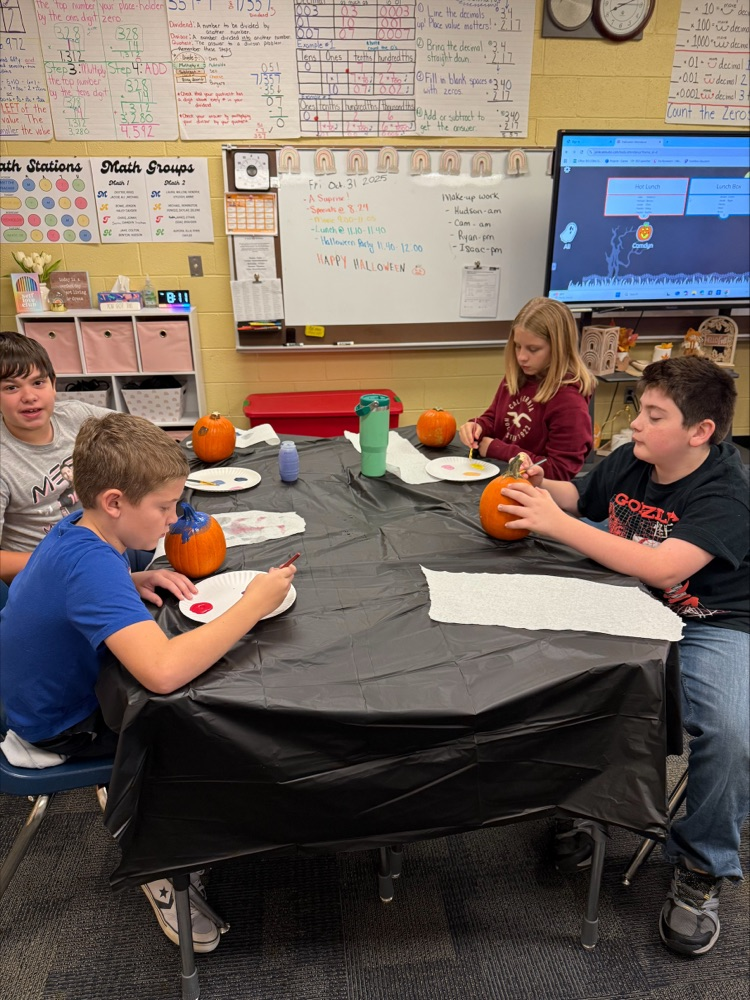 Students painting pumpkins. 