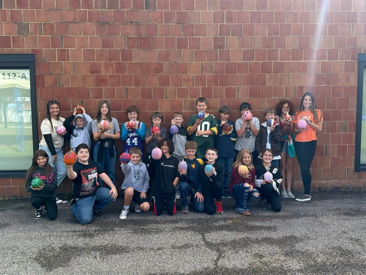 Ms. Long’s 5th grade class posing with their pumpkins  