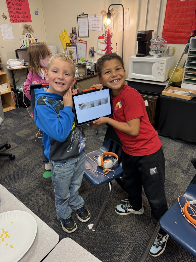two students holding IPad 