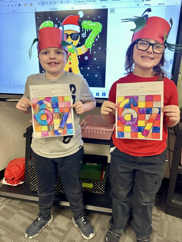 two students holding papers 